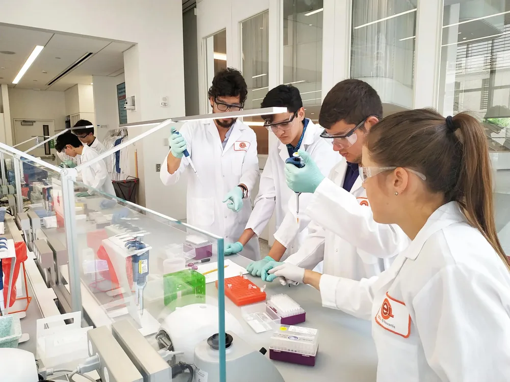 Students in lab coats during a STEAM science session in Boston